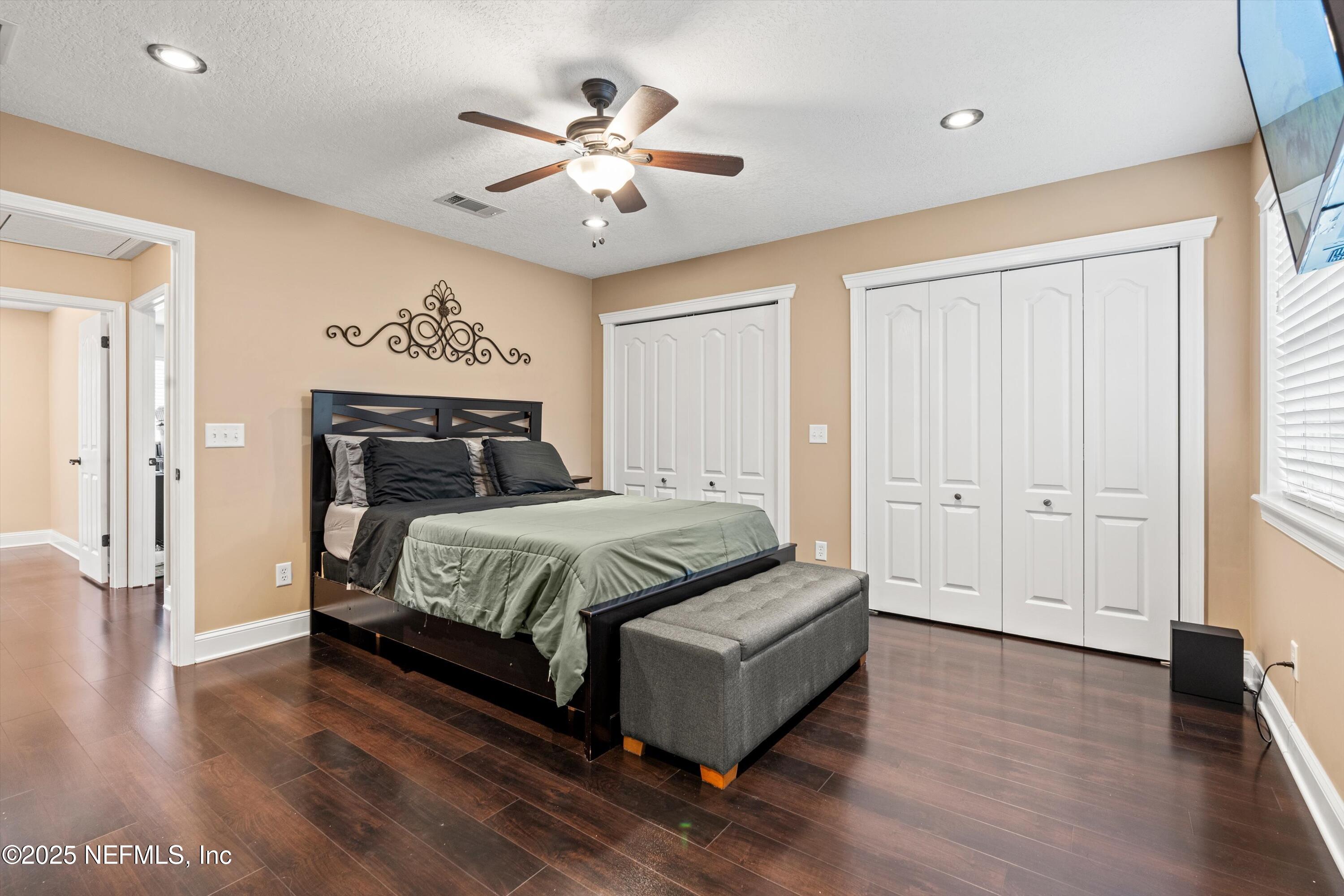 4807 Evenlode Lane Jacksonville, FL 32217 - Photo 12 of 28 a spacious bedroom with a bed and a chandelier