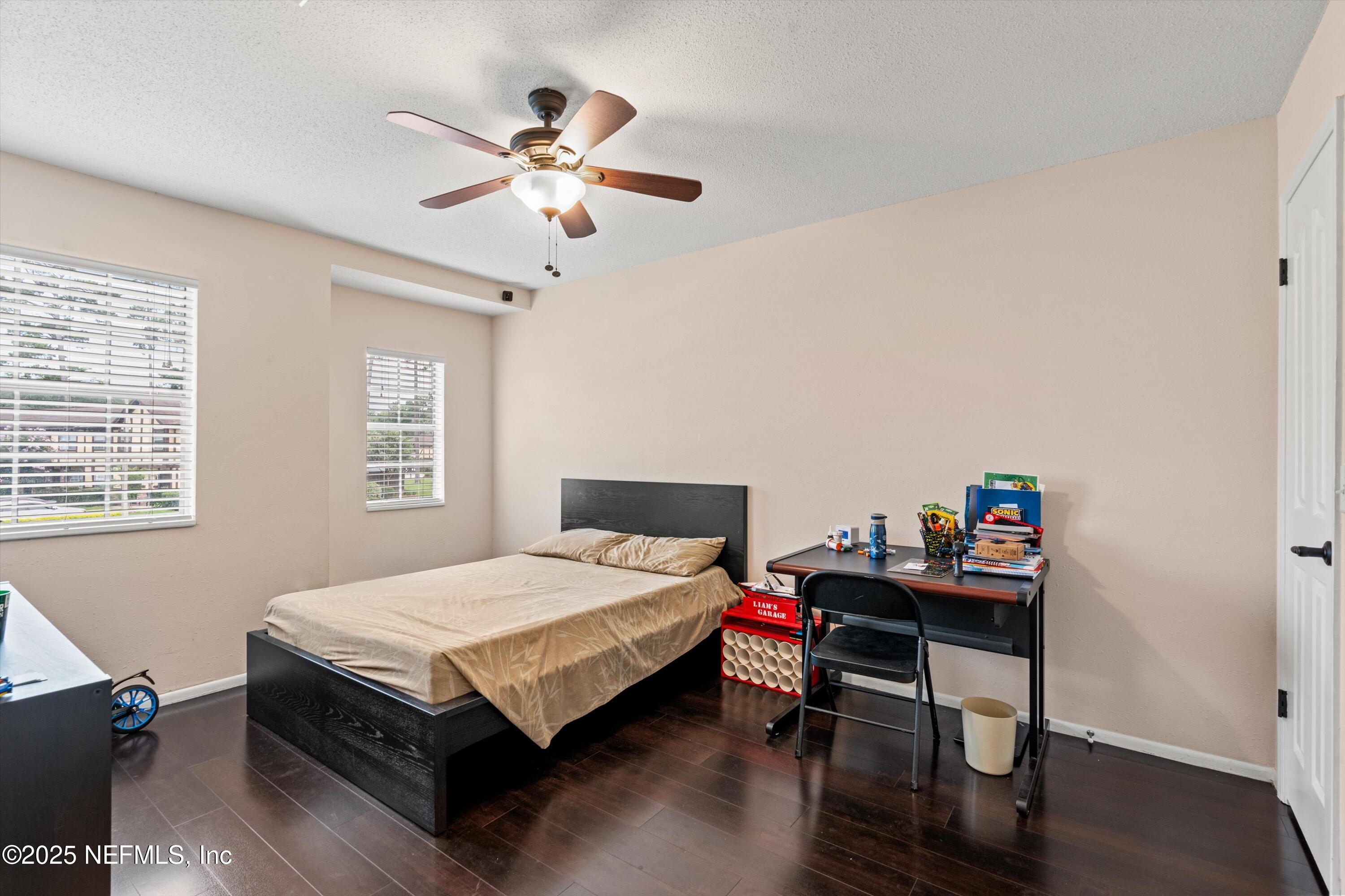 4807 Evenlode Lane Jacksonville, FL 32217 - Photo 15 of 28 a bedroom with a bed table and a window