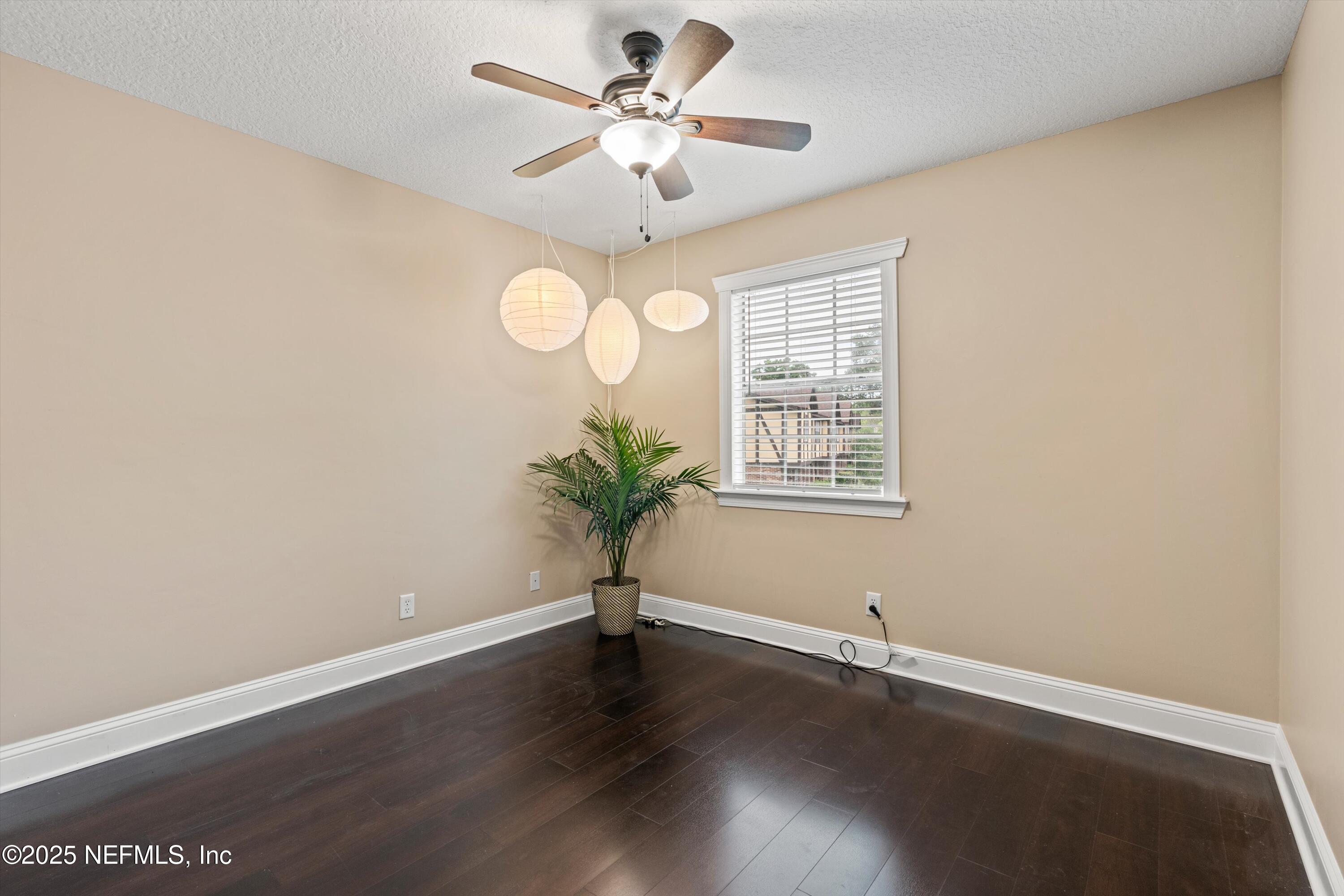 4807 Evenlode Lane Jacksonville, FL 32217 - Photo 16 of 28 an empty room with wooden floor and windows