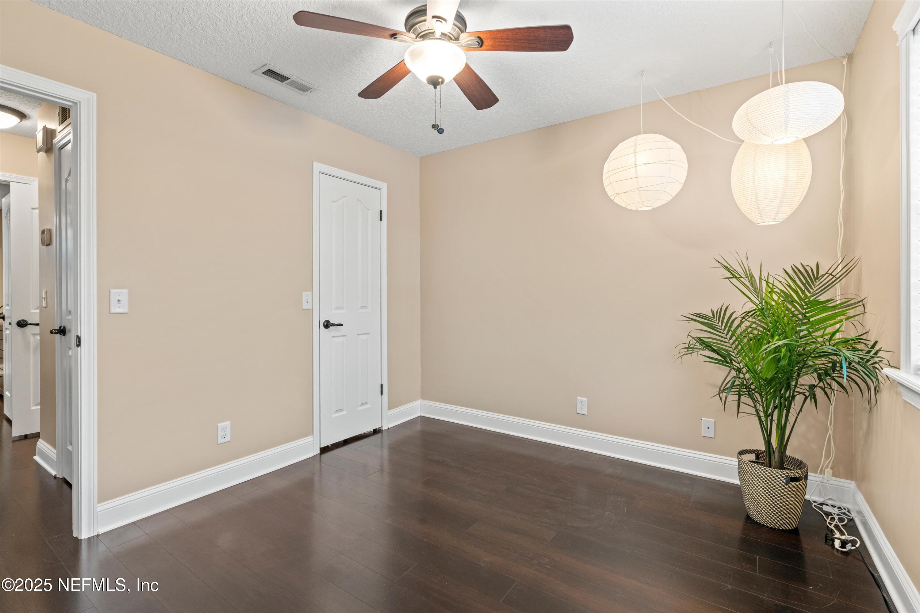 4807 Evenlode Lane Jacksonville, FL 32217 - Photo 17 of 28 a view of a room with wooden floor and a chandelier fan
