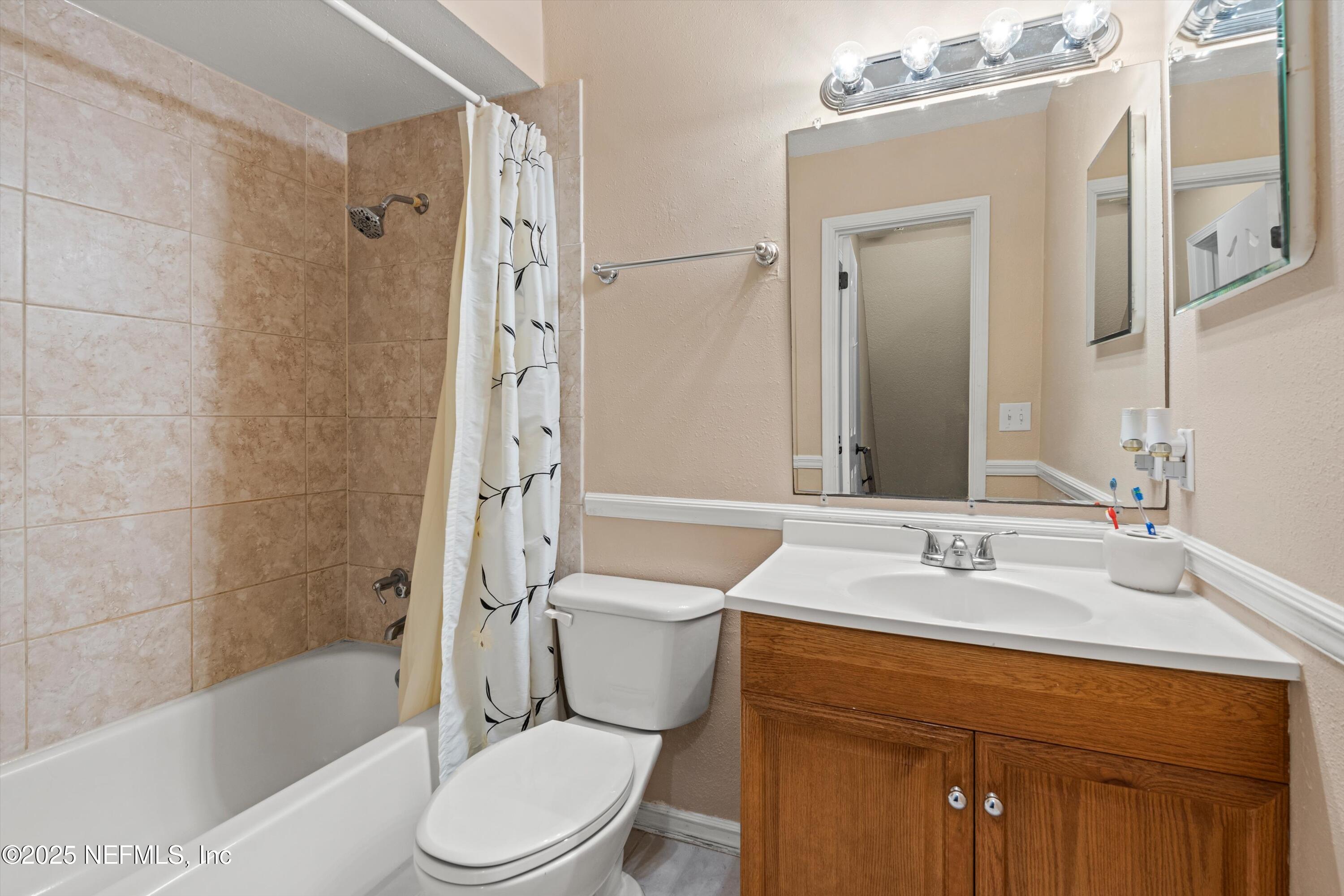 4807 Evenlode Lane Jacksonville, FL 32217 - Photo 18 of 28 a bathroom with a sink a toilet and shower