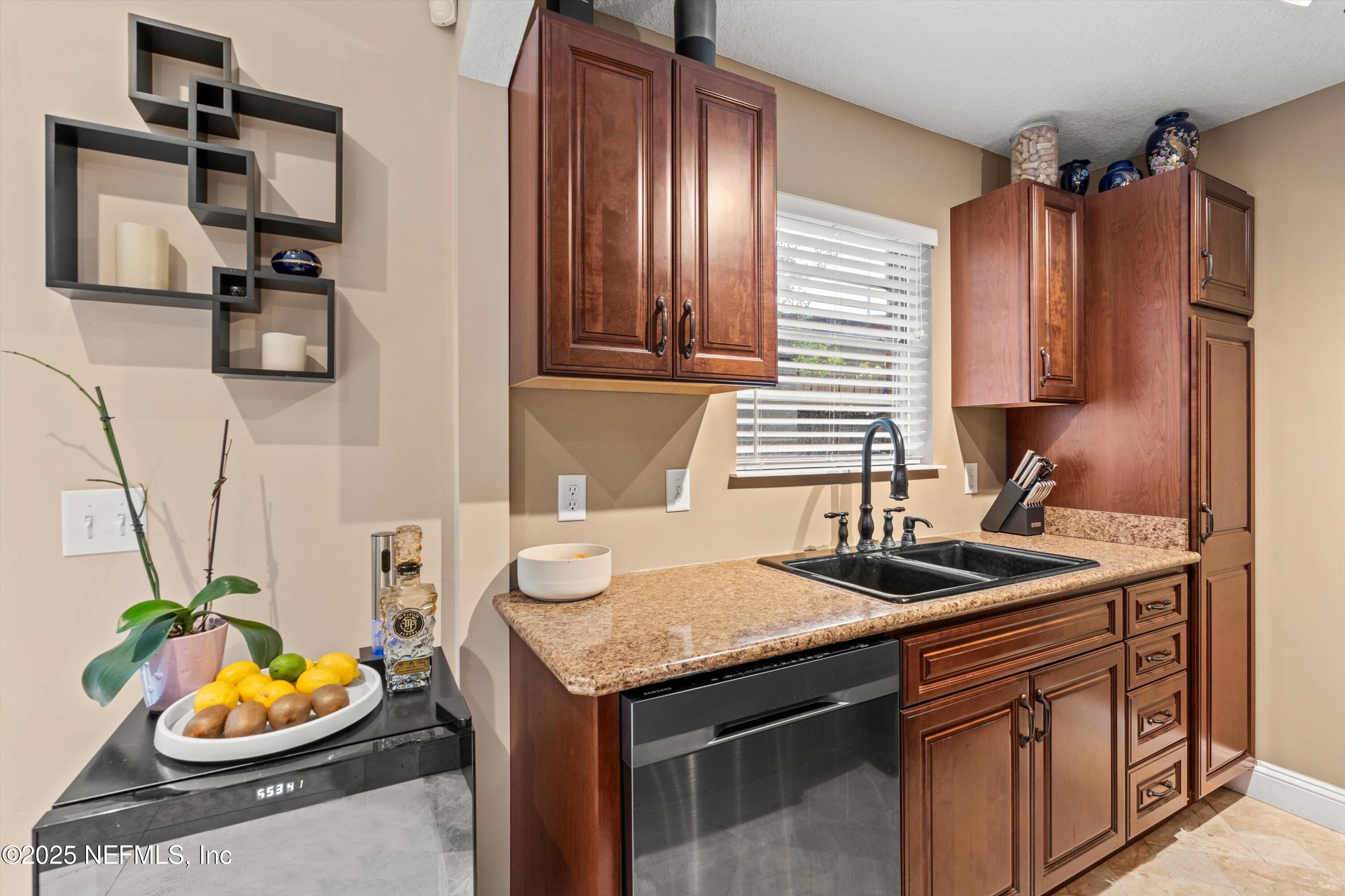 4807 Evenlode Lane Jacksonville, FL 32217 - Photo 9 of 28 a kitchen with a sink and a stove top oven