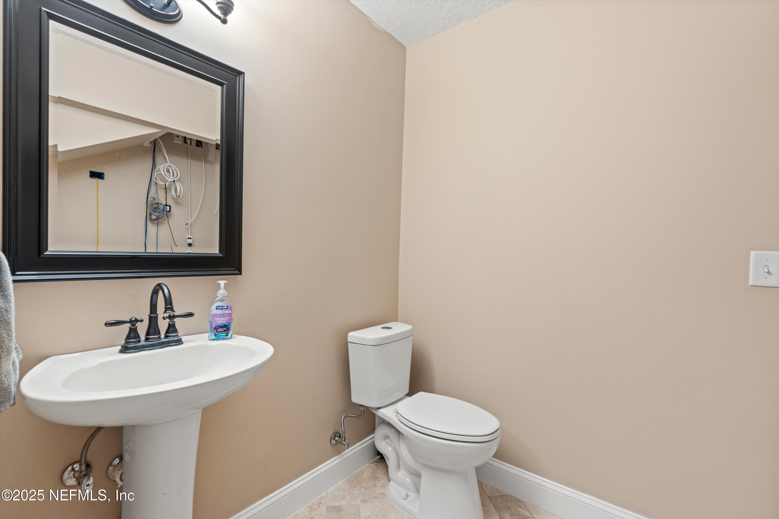 4807 Evenlode Lane Jacksonville, FL 32217 - Photo 10 of 28 a bathroom with a toilet a sink and mirror