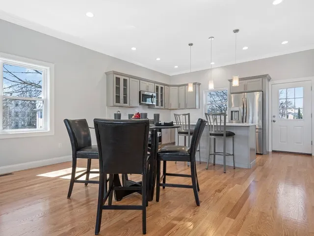 a dining room with furniture and wooden floor