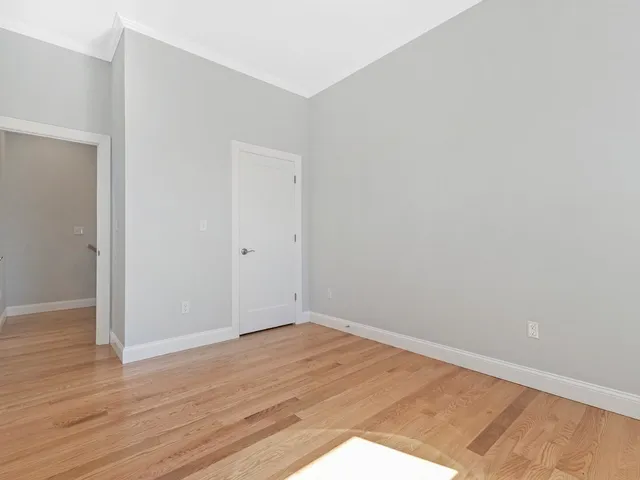 an empty room with wooden floor
