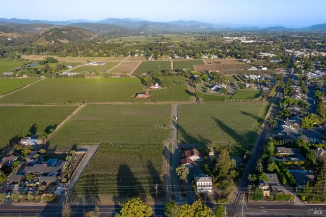 an aerial view of lake and residential houses with outdoor space