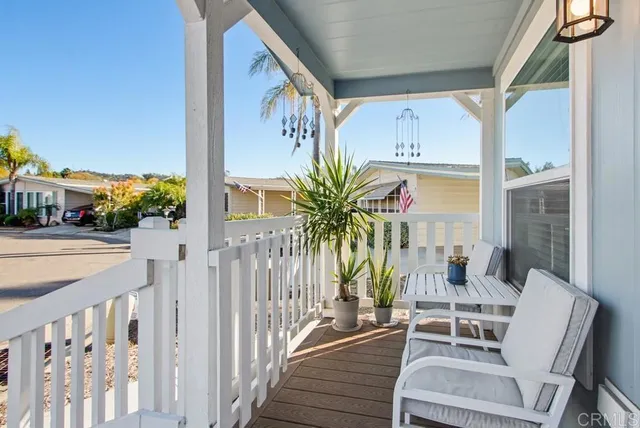 a view of a house with a yard siting area and garden