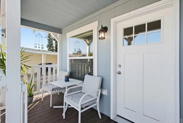 a view of a house with a small yard and wooden fence