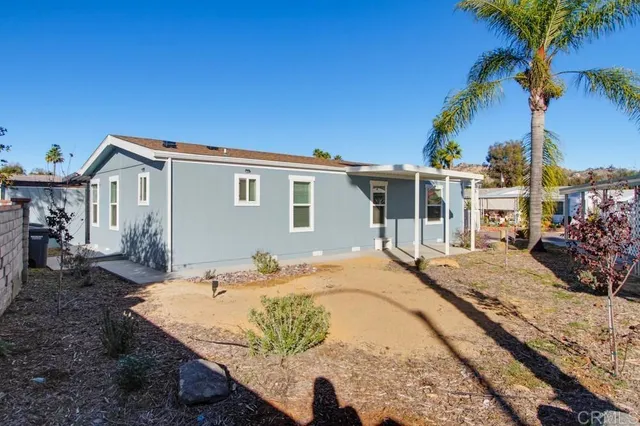 a bedroom with furniture and large window