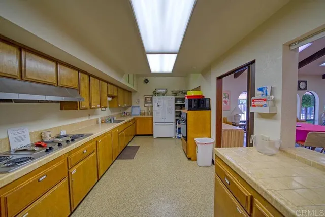 a room with pool table and windows