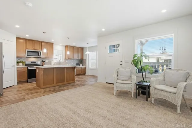 a living room with furniture and a kitchen