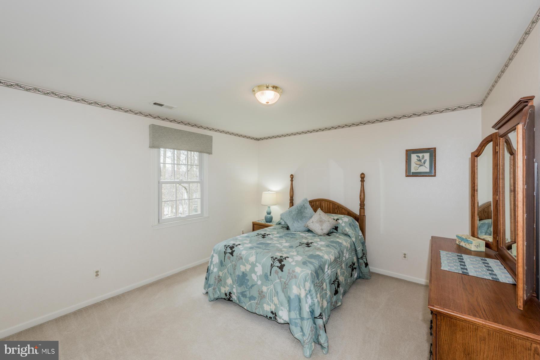 5 Wetherbee Court Phoenix, MD 21131 - Photo 22 of 29 a bedroom with a bed and a flat screen tv