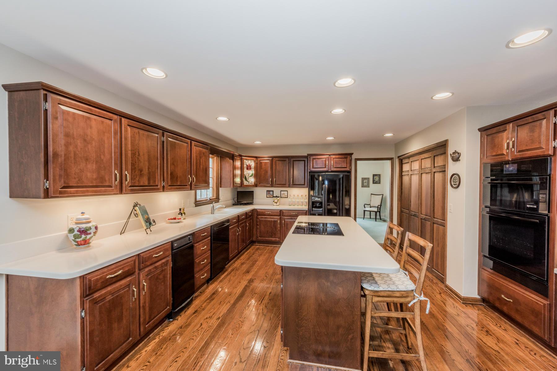 5 Wetherbee Court Phoenix, MD 21131 - Photo 8 of 29 a large kitchen with stainless steel appliances lots of counter space and wooden floor