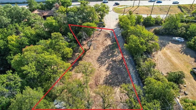 an aerial view of a house with a yard and potted plants