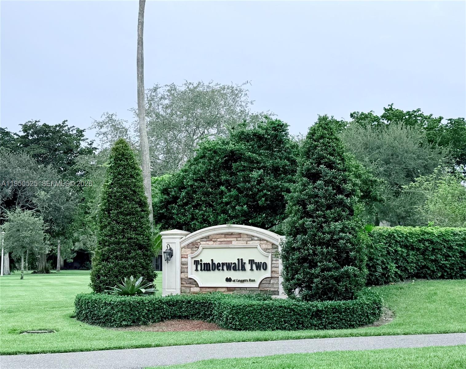 22279 Woodborn Drive Boca Raton, FL 33428 - Photo 14 of 19 a sign board with tall trees in the background