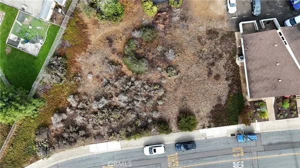 an aerial view of a house with a yard