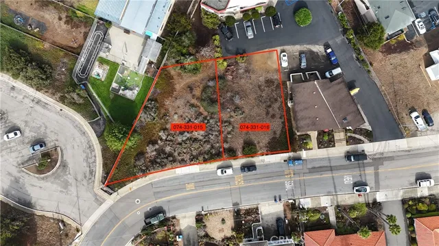 an aerial view of a house with a yard and large trees