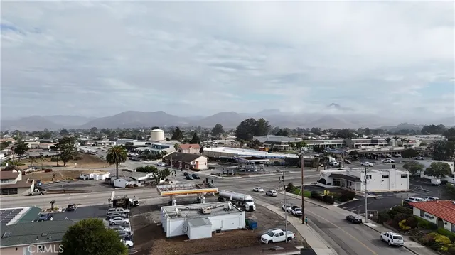 an aerial view of a house with a yard and large trees