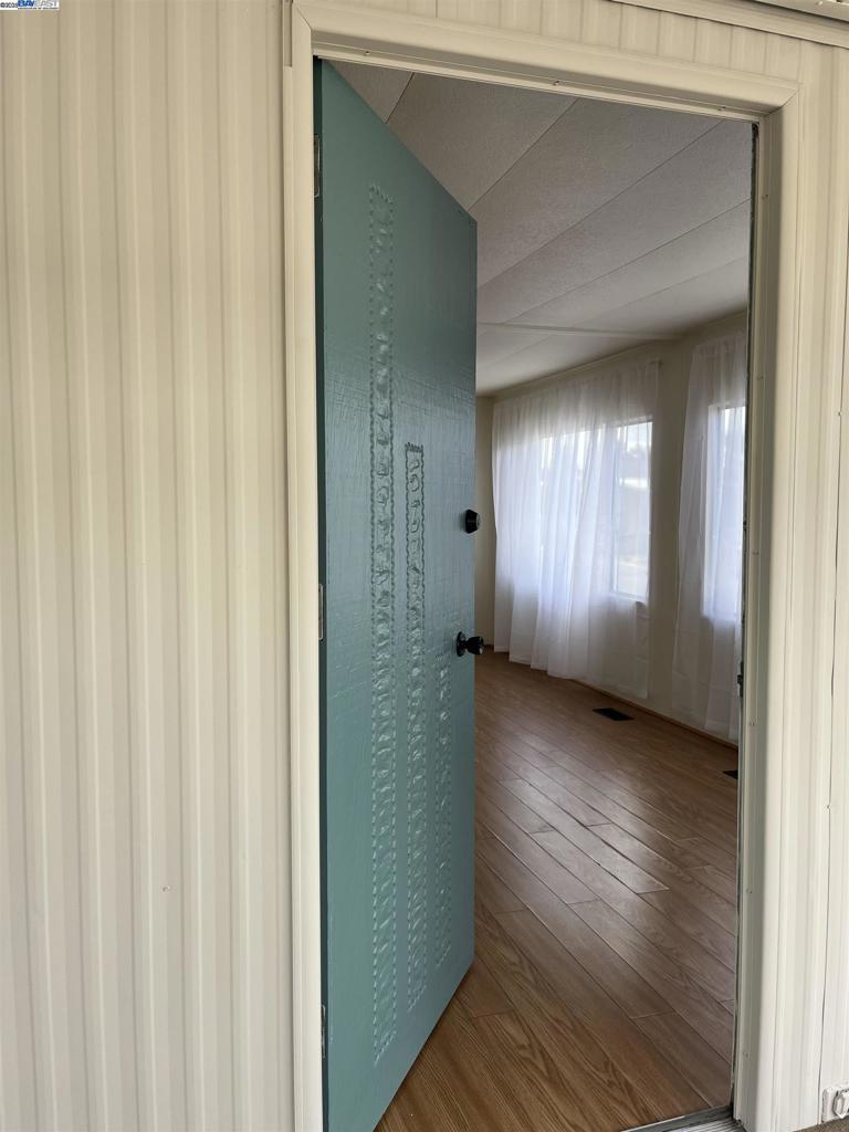 1085 Tasman Sunnyvale, CA 94089 - Photo 15 of 33 a view of a hallway with wooden floor and windows