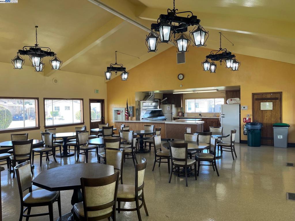 1085 Tasman Sunnyvale, CA 94089 - Photo 26 of 33 a dining hall with couches a dining table and chairs with wooden floor
