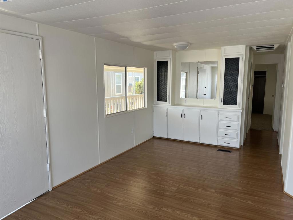 1085 Tasman Sunnyvale, CA 94089 - Photo 6 of 33 a view of an empty room with wooden floor and a window