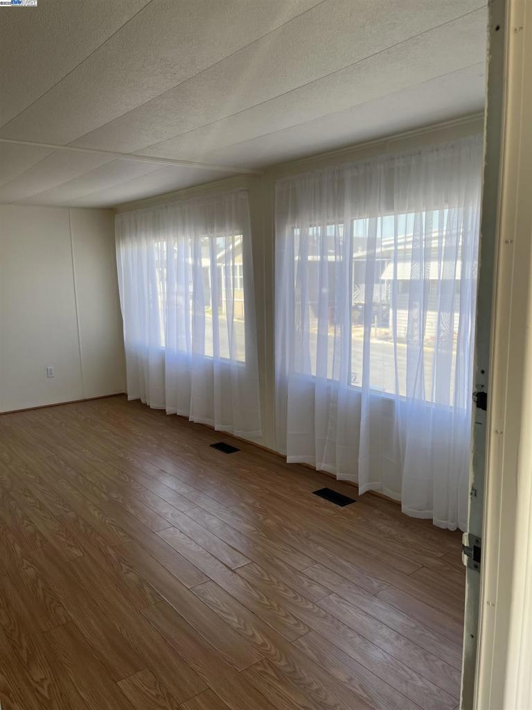 1085 Tasman Sunnyvale, CA 94089 - Photo 7 of 33 an empty room with wooden floor and windows