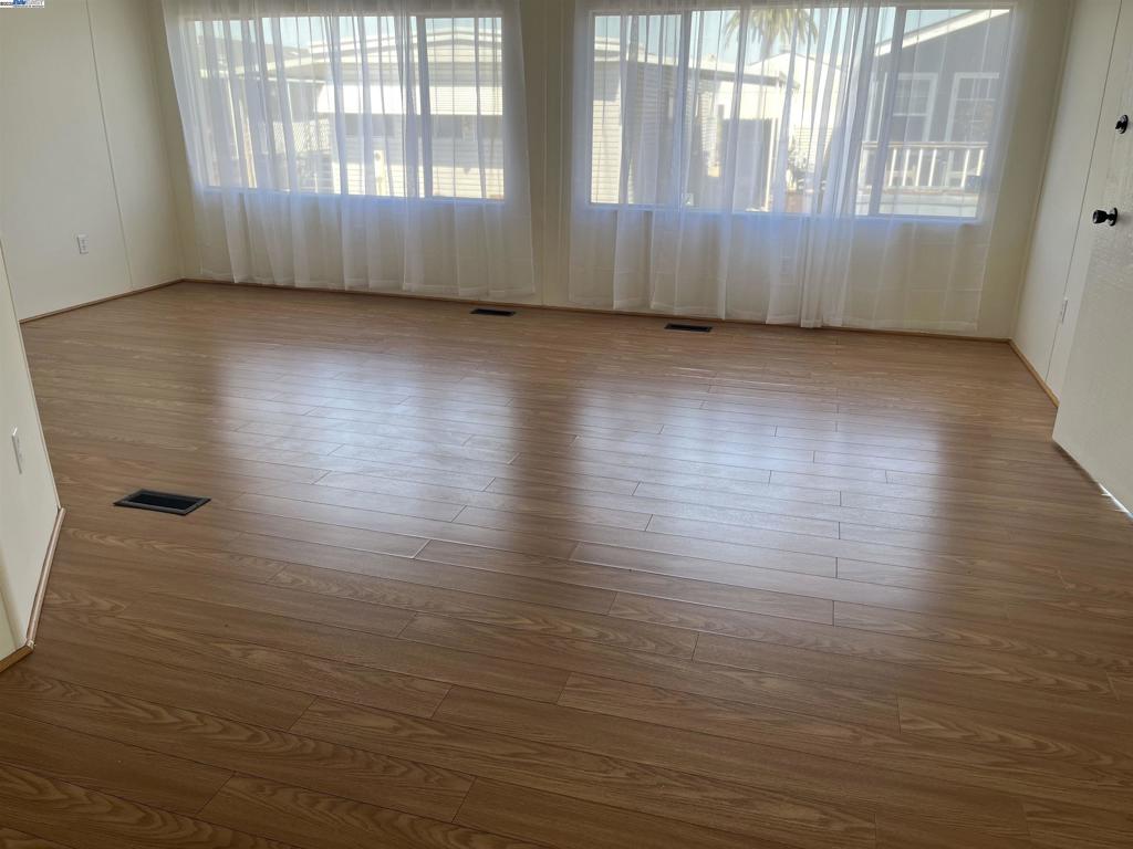 1085 Tasman Sunnyvale, CA 94089 - Photo 8 of 33 an empty room with wooden floor and windows