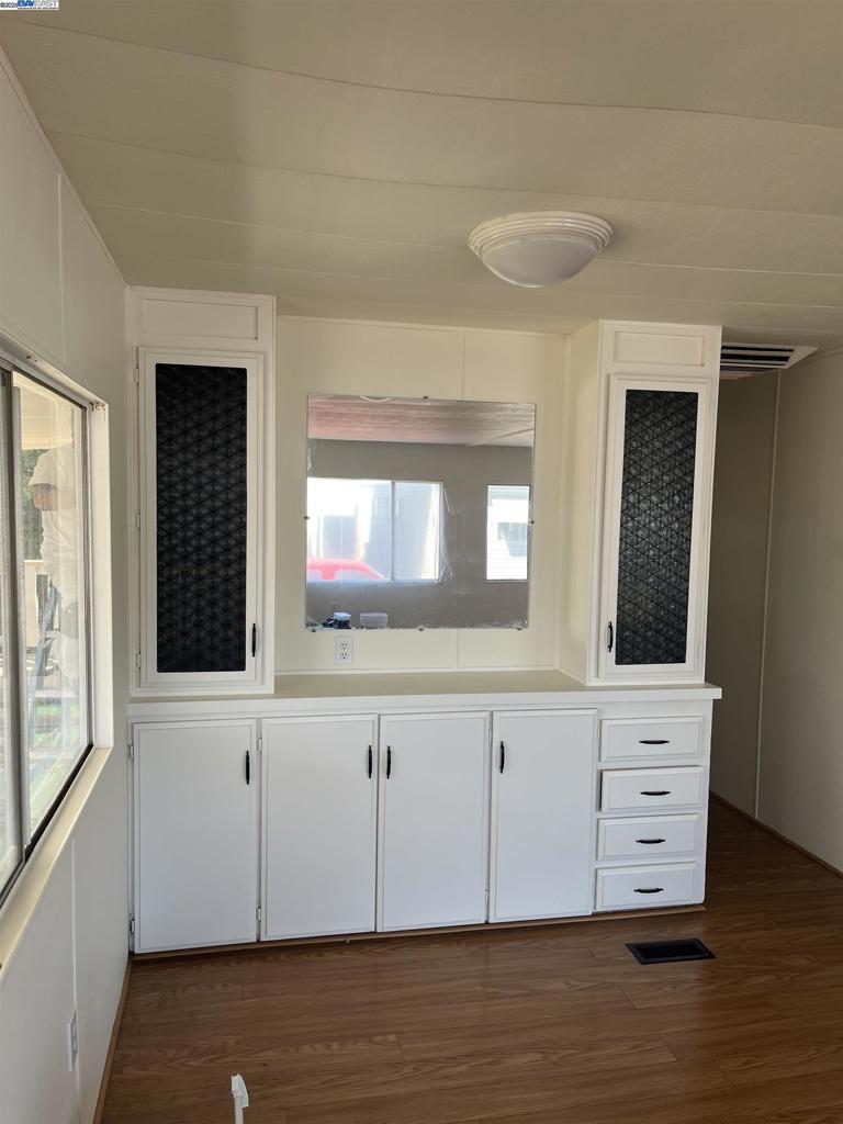 1085 Tasman Sunnyvale, CA 94089 - Photo 9 of 33 a view of an empty room with wooden floor and a window