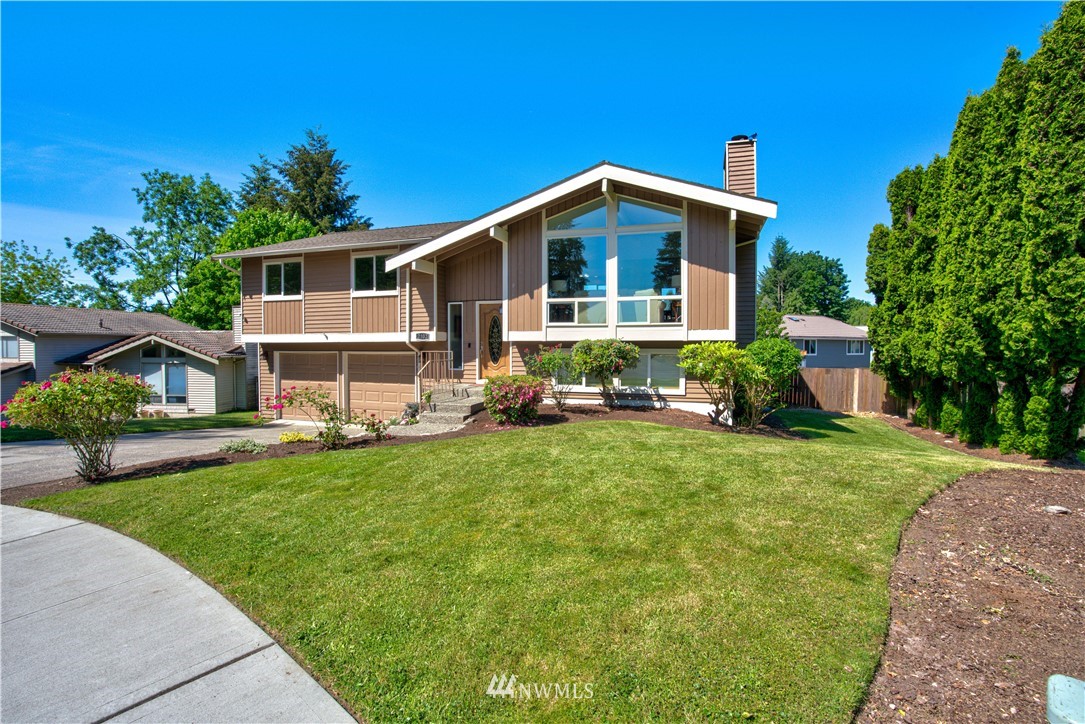 2103 Southeast 21st Street Renton, WA 98055 - Photo 2 of 23 a front view of a house with garden