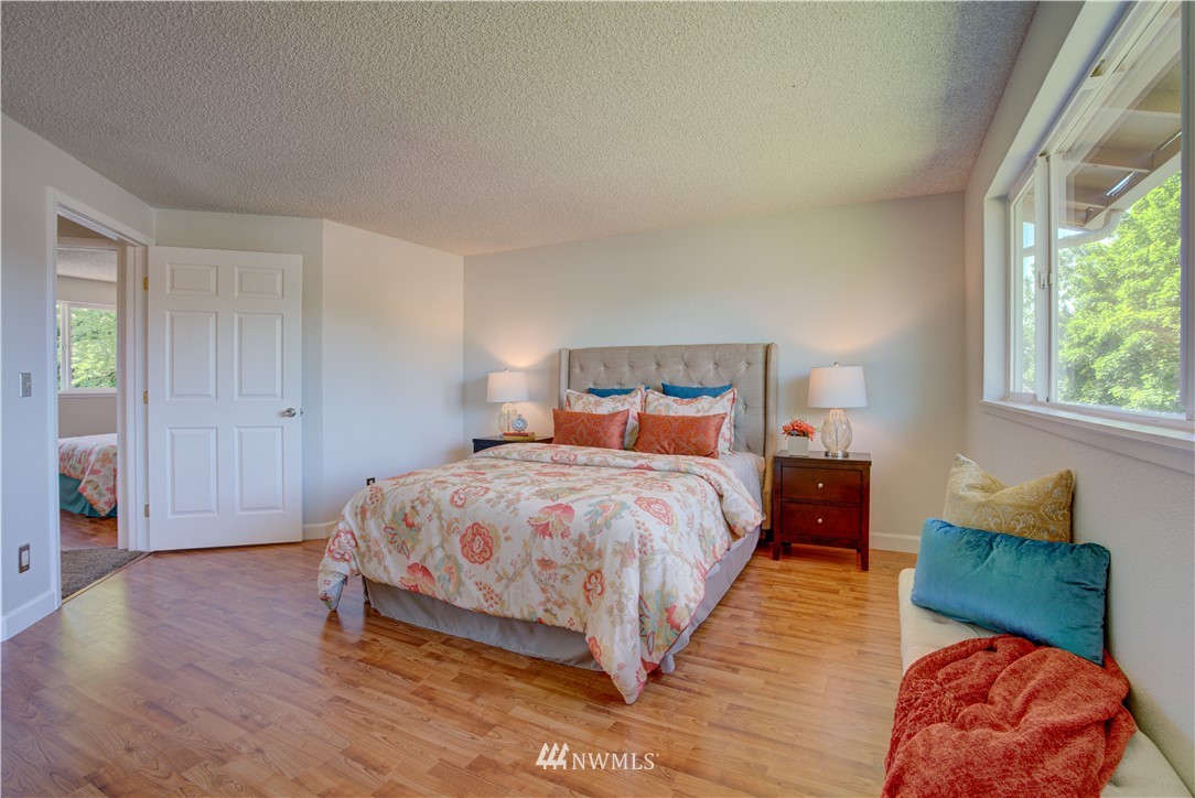 2103 Southeast 21st Street Renton, WA 98055 - Photo 12 of 23 a bedroom with a bed and wooden floor