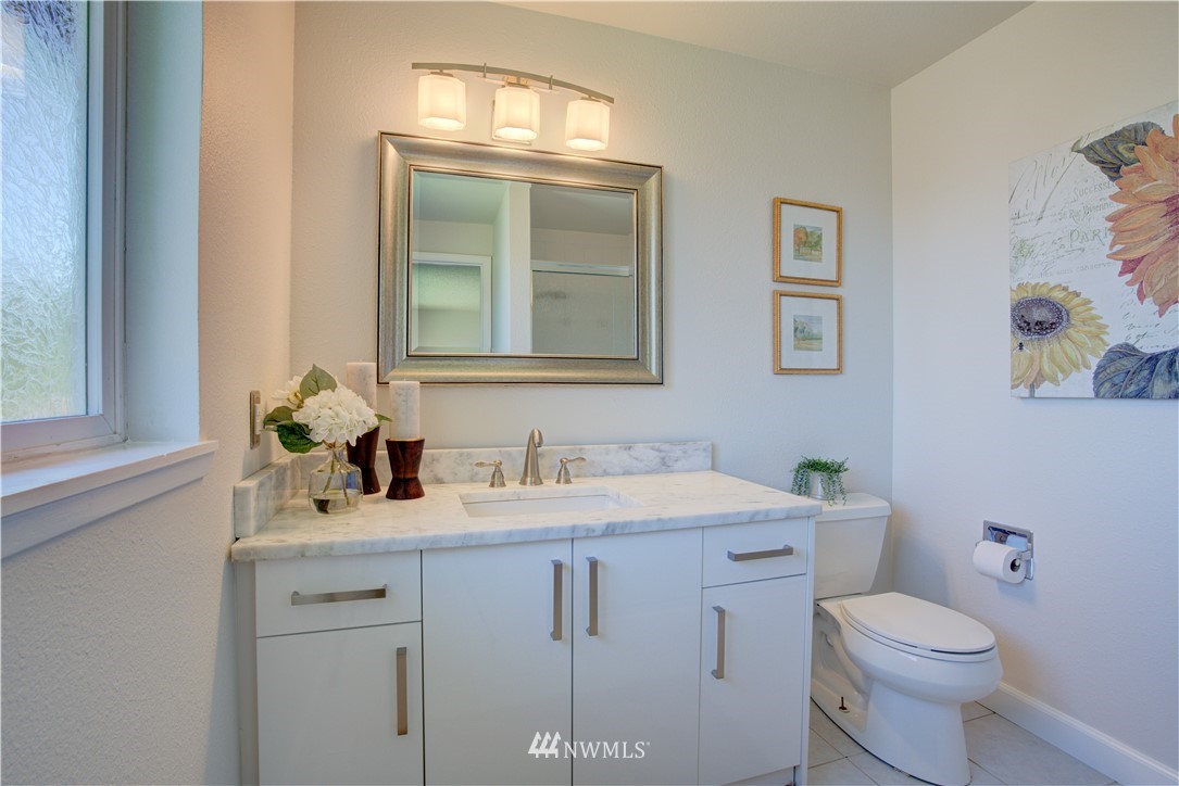2103 Southeast 21st Street Renton, WA 98055 - Photo 14 of 23 a bathroom with a toilet sink and mirror