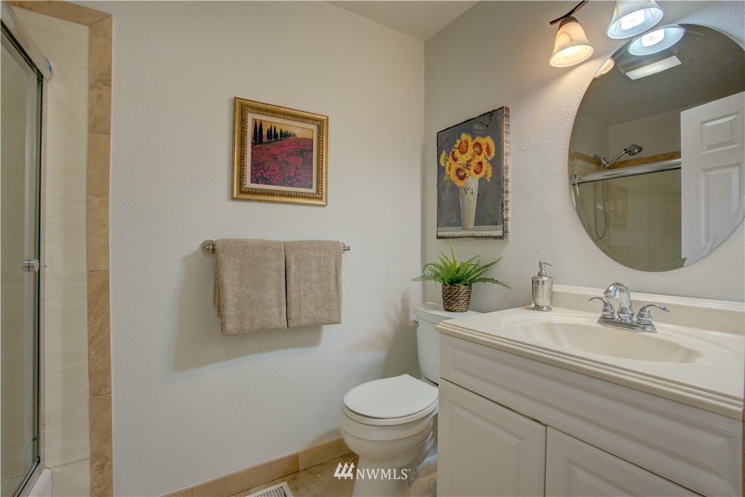 2103 Southeast 21st Street Renton, WA 98055 - Photo 17 of 23 a bathroom with a toilet a sink and mirror