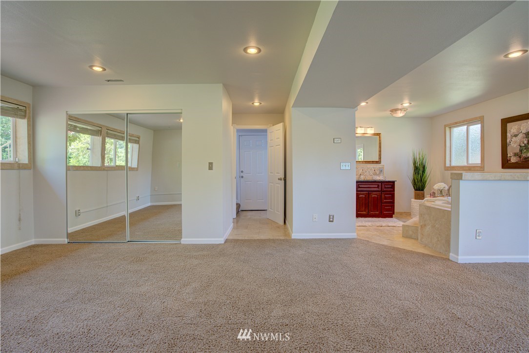 2103 Southeast 21st Street Renton, WA 98055 - Photo 18 of 23 an empty room with kitchen view and windows