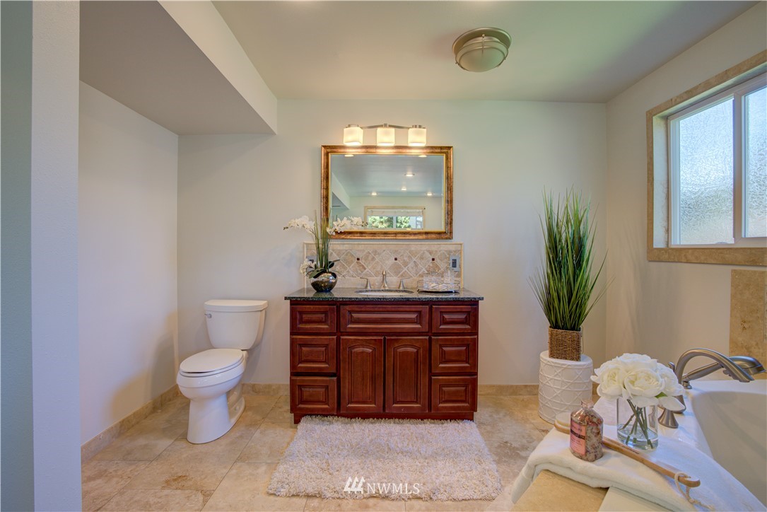 2103 Southeast 21st Street Renton, WA 98055 - Photo 21 of 23 a bathroom with a toilet sink and mirror