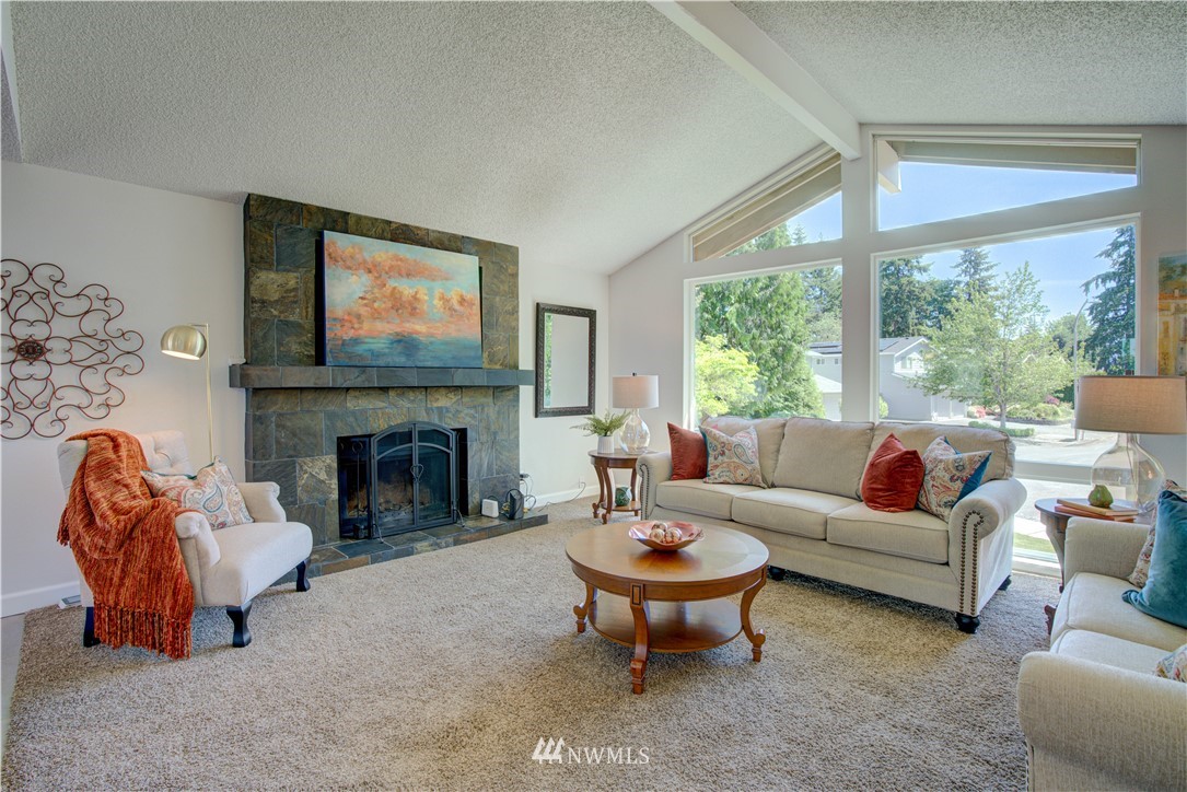 2103 Southeast 21st Street Renton, WA 98055 - Photo 4 of 23 a living room with furniture a fireplace and a large window