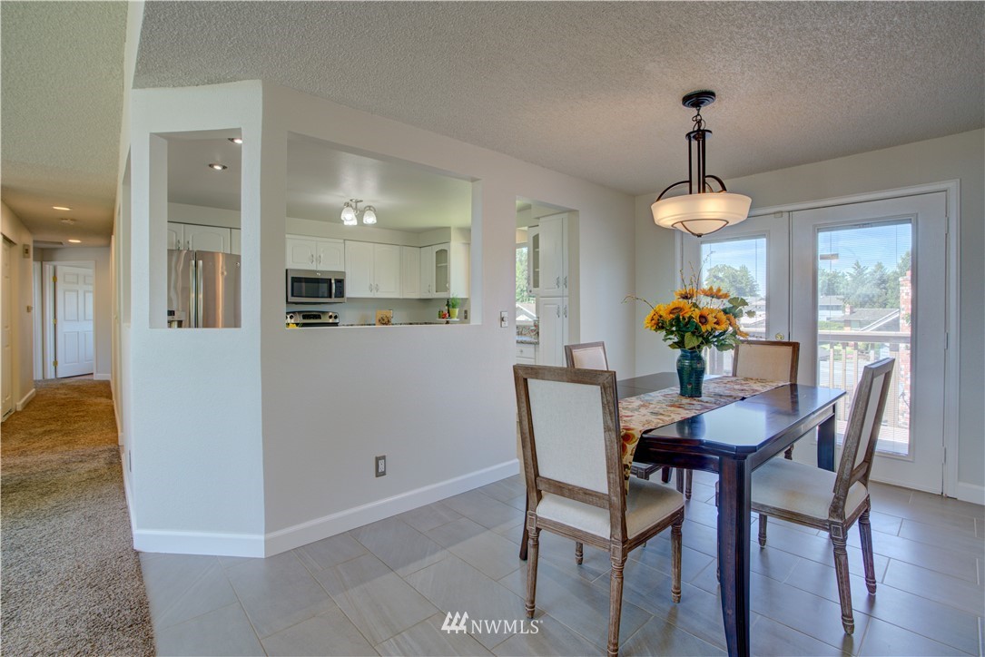 2103 Southeast 21st Street Renton, WA 98055 - Photo 7 of 23 a view of a dining room with furniture and chandelier
