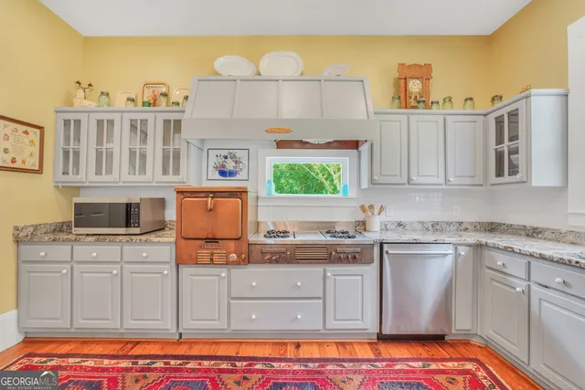 a bathroom with a granite countertop toilet sink and mirror