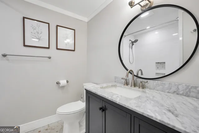 a bathroom with a sink a toilet a tub and mirror