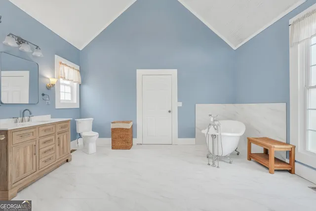 a view of a house with a yard and sitting area