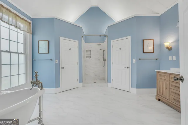 a view of a house with backyard and a tree