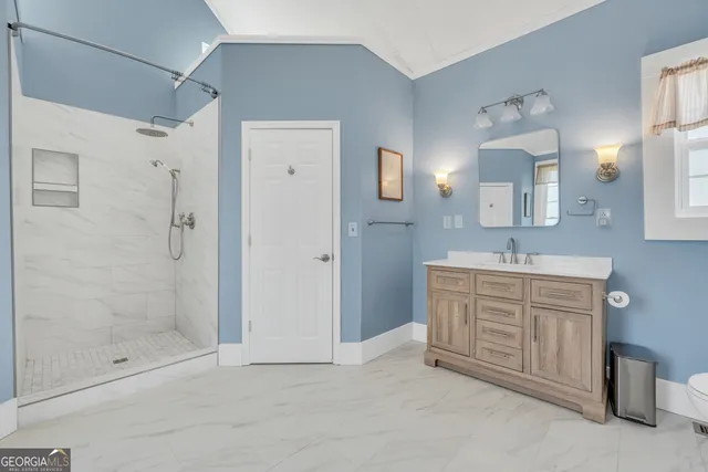 a view of a lake with a bench and trees