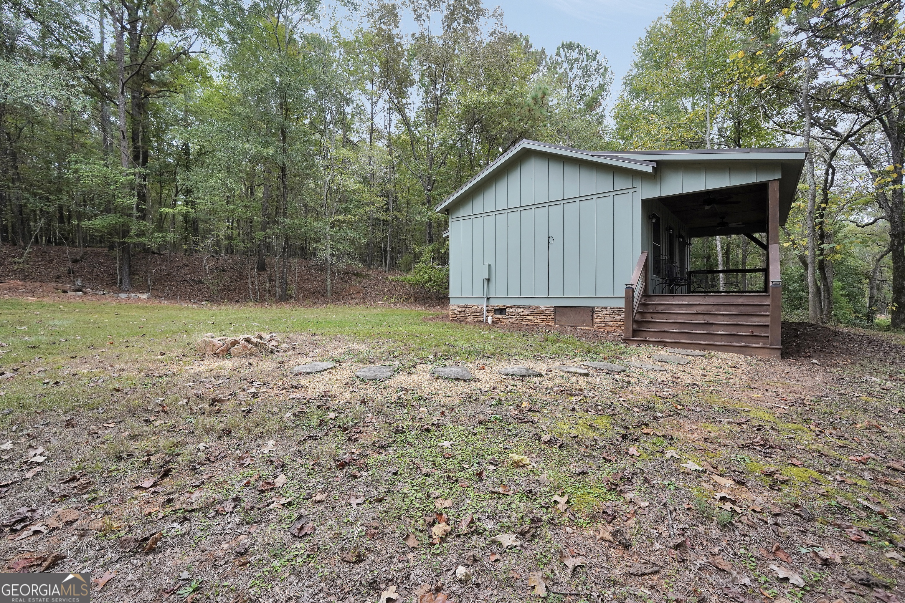 686 Burkett Road Thomaston, GA 30286 - Photo 55 of 70 a backyard of a house with wooden fence and large trees