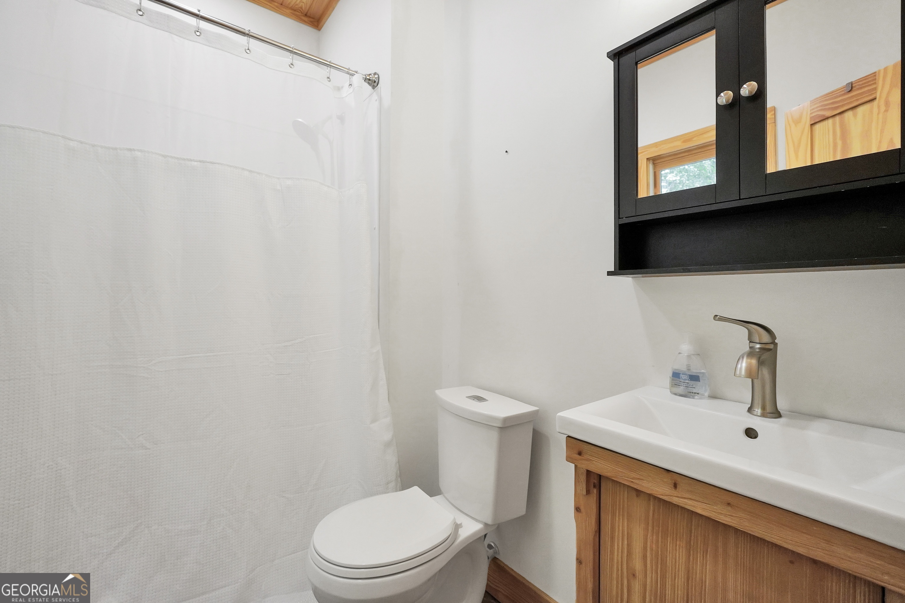 686 Burkett Road Thomaston, GA 30286 - Photo 63 of 70 a bathroom with a toilet a sink and a window