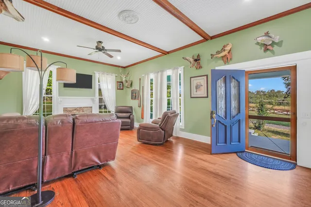 a living room with furniture and wooden floor