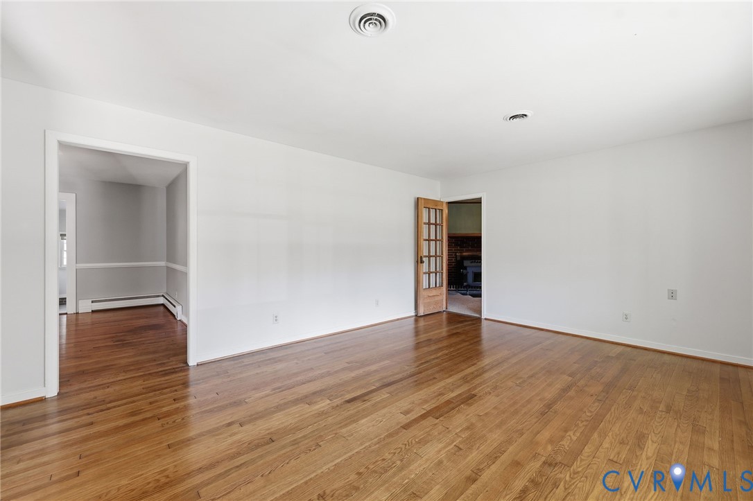 12673 Winfree Street Chester, VA 23831 - Photo 12 of 31 a view of an empty room with wooden floor and closet
