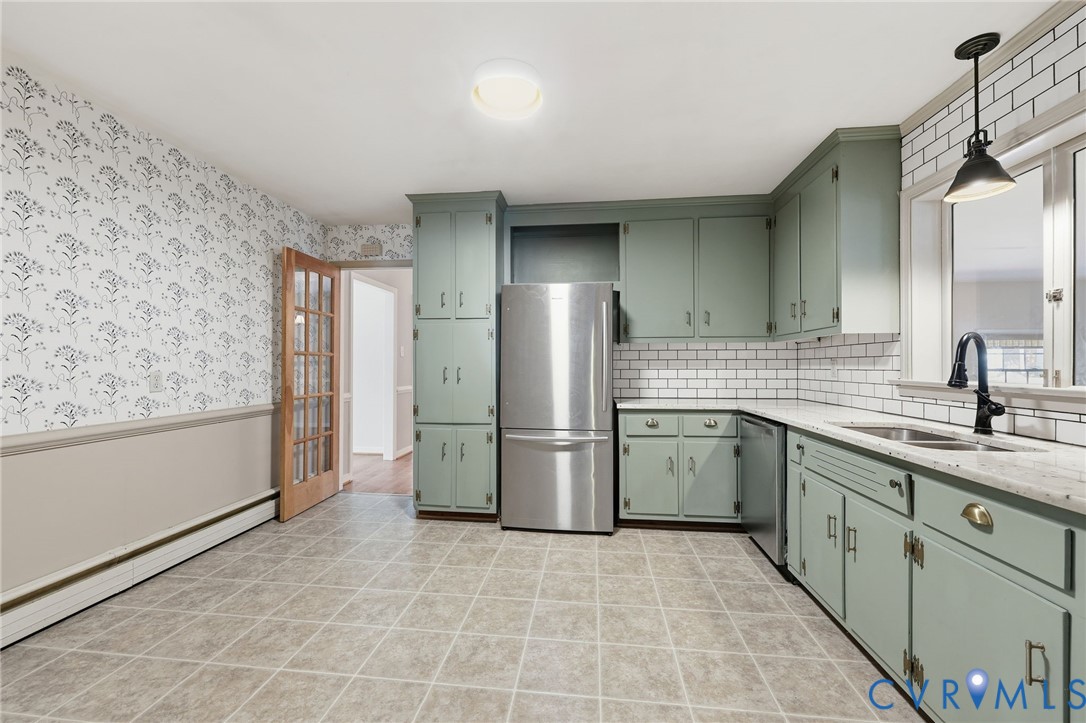 12673 Winfree Street Chester, VA 23831 - Photo 18 of 31 a kitchen with a sink cabinets and refrigerator