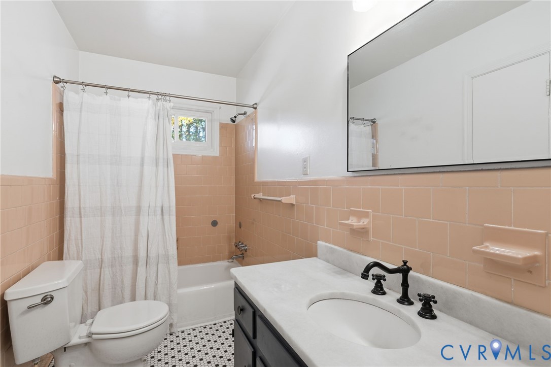 12673 Winfree Street Chester, VA 23831 - Photo 24 of 31 a bathroom with a sink a toilet and shower