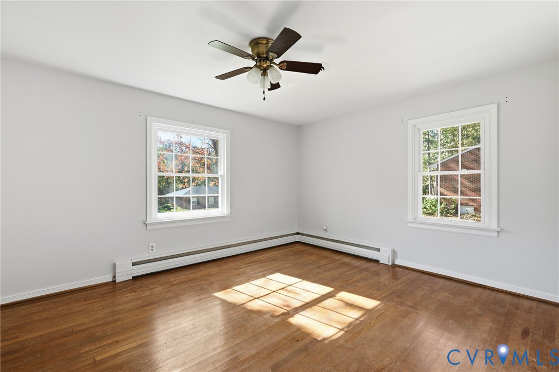 12673 Winfree Street Chester, VA 23831 - Photo 28 of 31 an empty room with wooden floor and windows