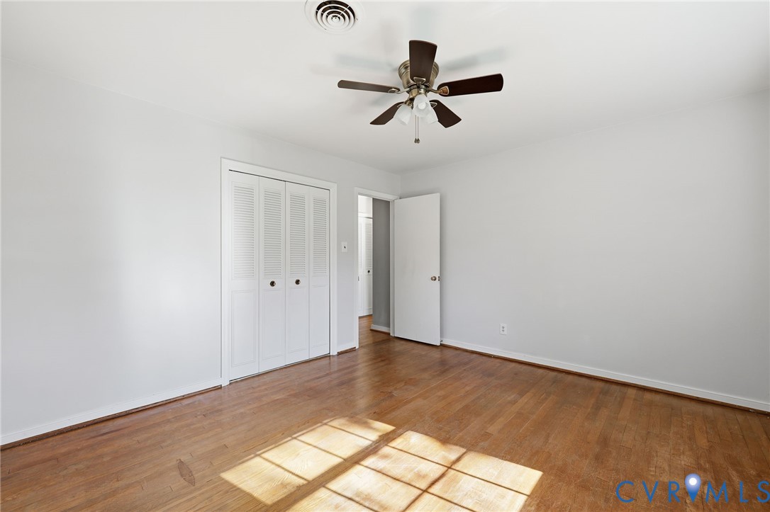 12673 Winfree Street Chester, VA 23831 - Photo 29 of 31 a view of a big room with wooden floor closet and windows