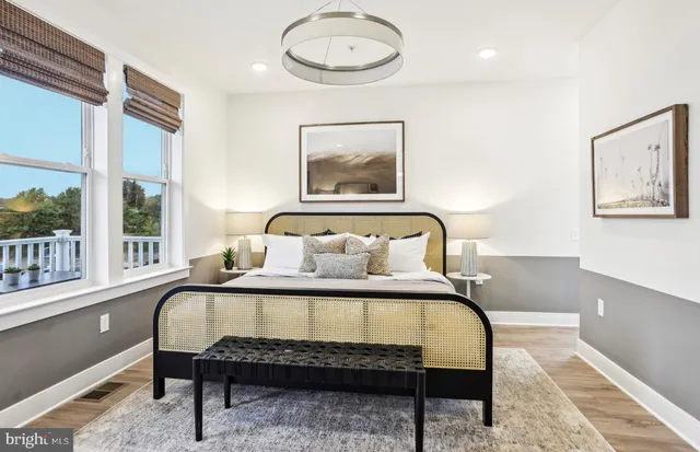 a bedroom with a bed and painting on the wall